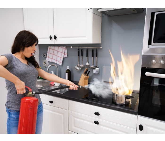 Woman using fire extinguisher 